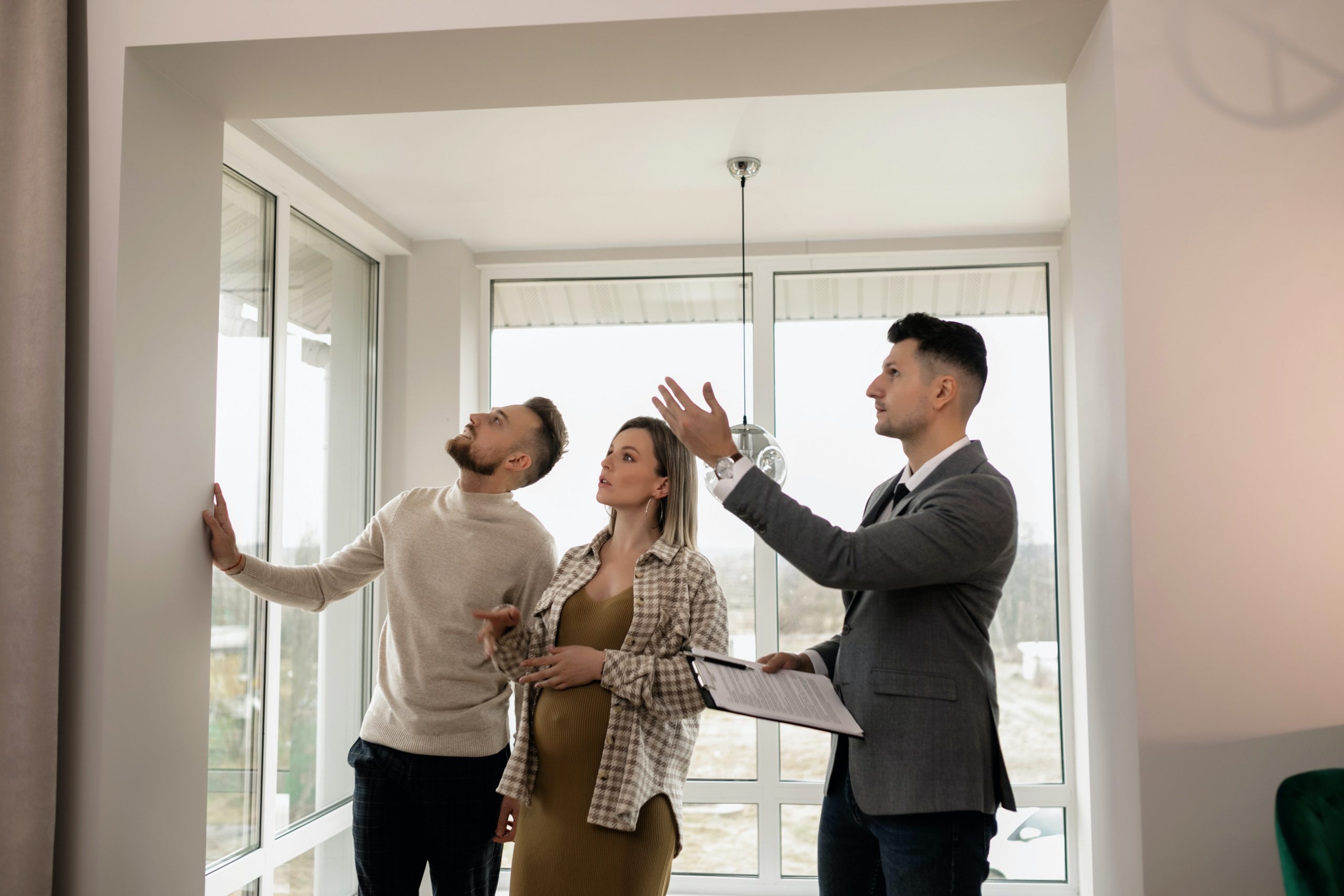 Couple touring a house with their real estate agent
